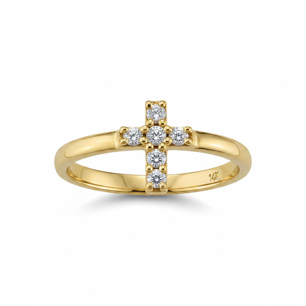 A gold ring featuring a cross-shaped top set with small clear gemstones, photographed on a clean white background.