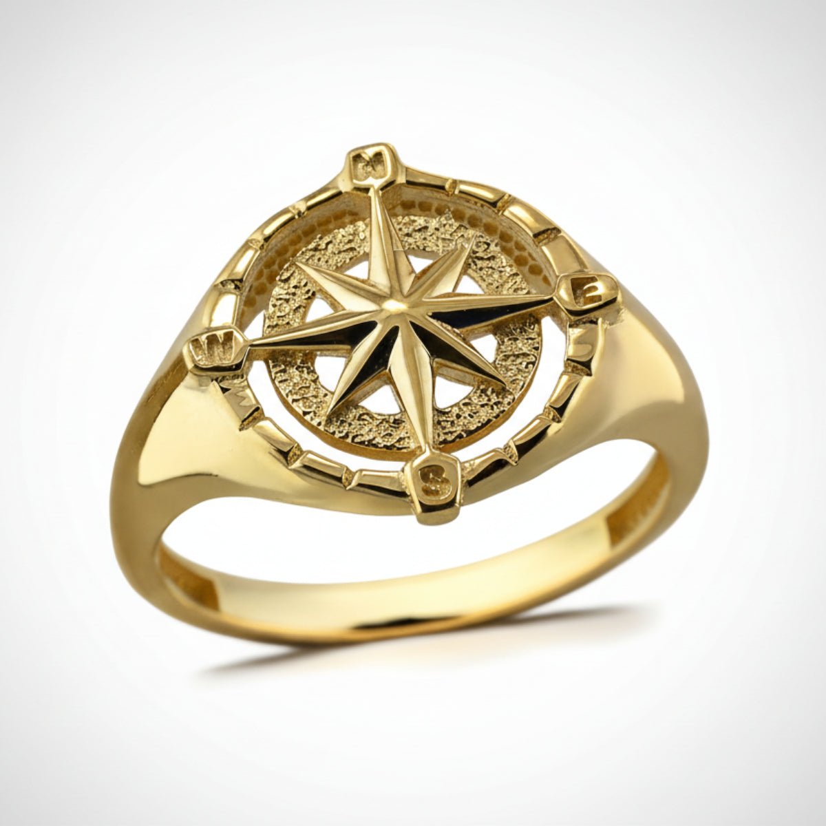 Gold ring with a compass design on a white background