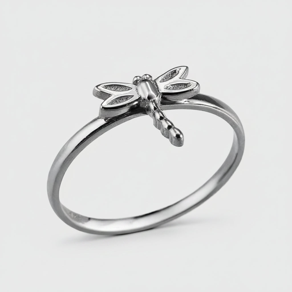 Silver dragonfly ring on a white background