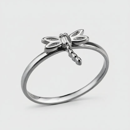 Silver dragonfly ring on a white background