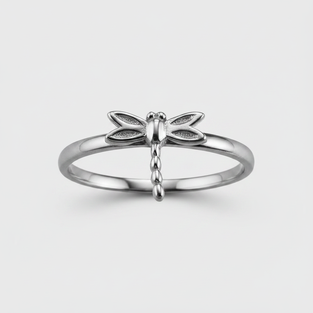 Silver dragonfly ring on a light gray background