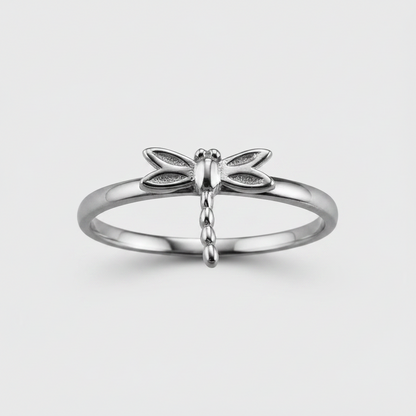 Silver dragonfly ring on a light gray background