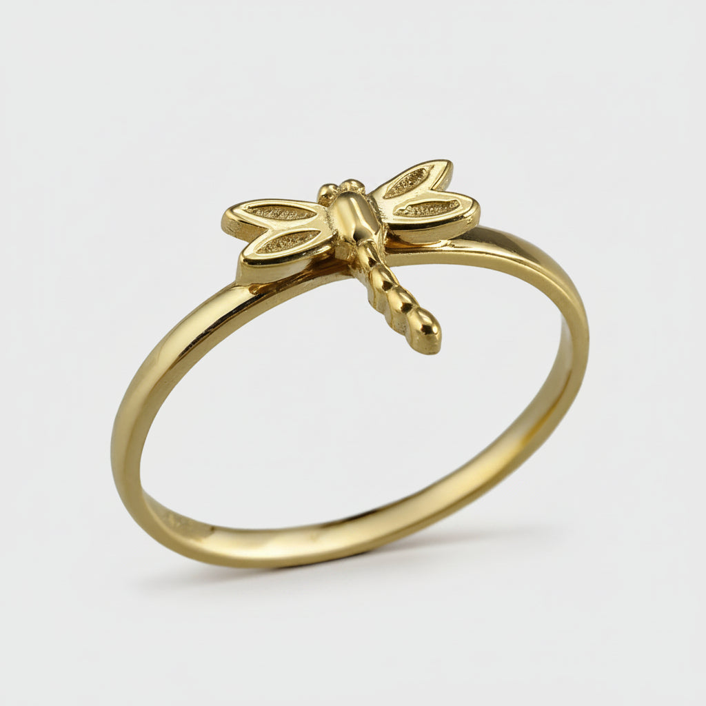 Gold dragonfly ring on a white background
