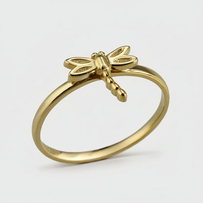 Gold dragonfly ring on a white background
