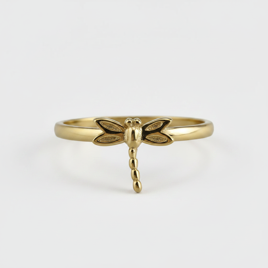 Gold dragonfly ring on a white background