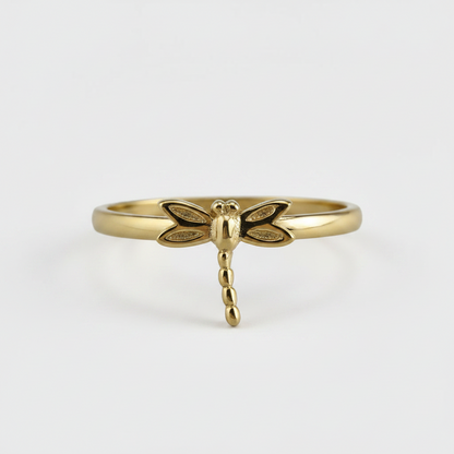 Gold dragonfly ring on a white background