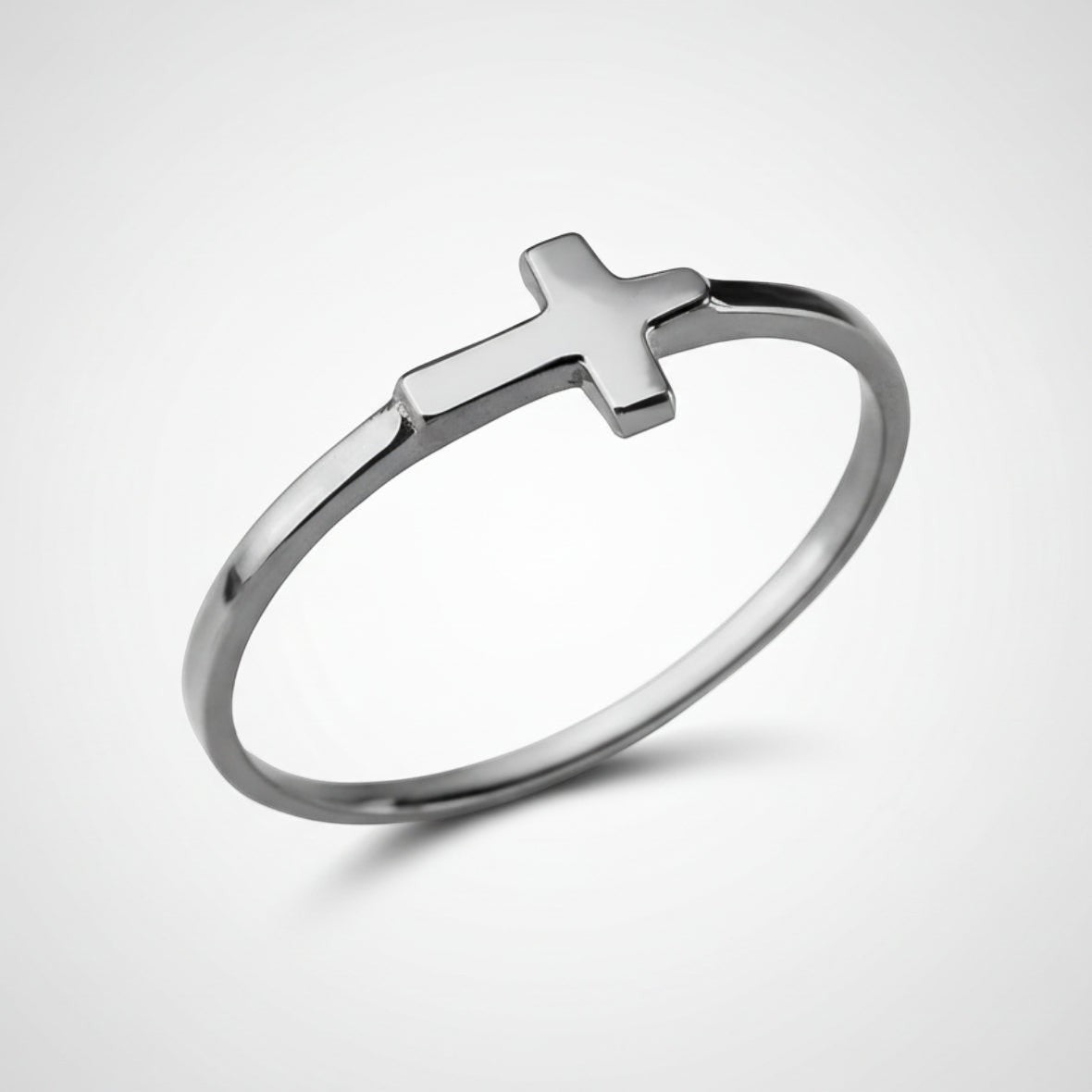 Silver ring with a cross on a white background