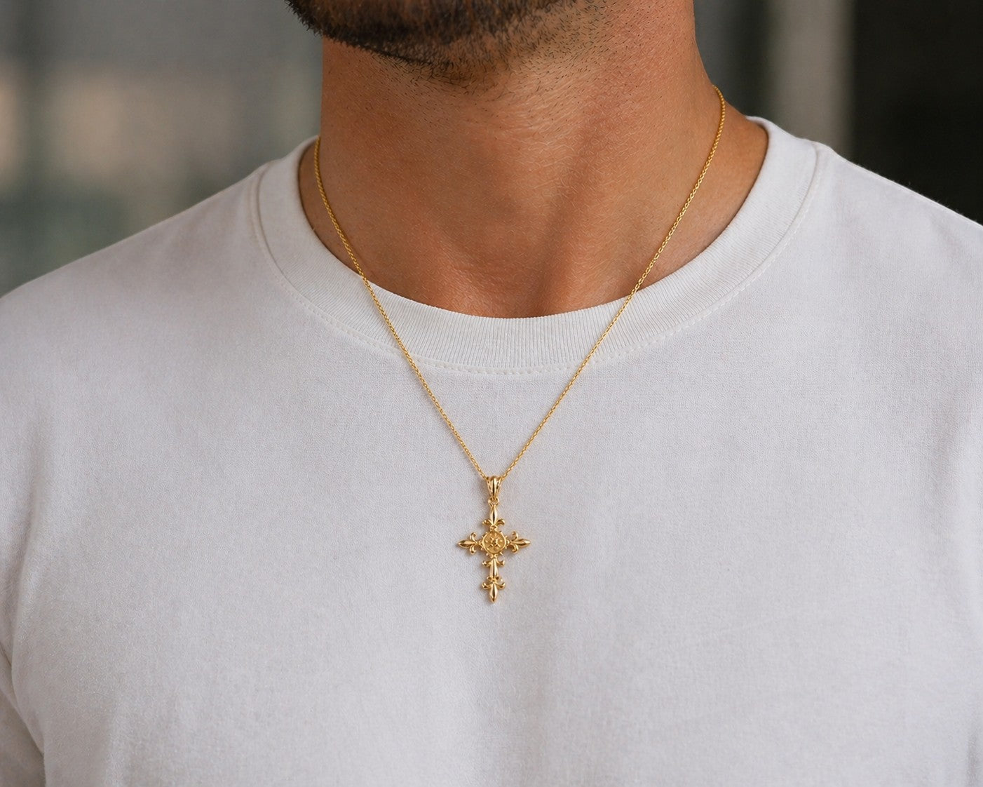 Karma Blingz yellow gold fleur de lis cross pendant necklace with a polished finish and textured center detail on a delicate rolo chain.