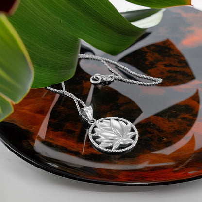 Karma Blingz sterling silver lotus flower pendant necklace with polished finish and delicate detailing, on a fine rolo chain.