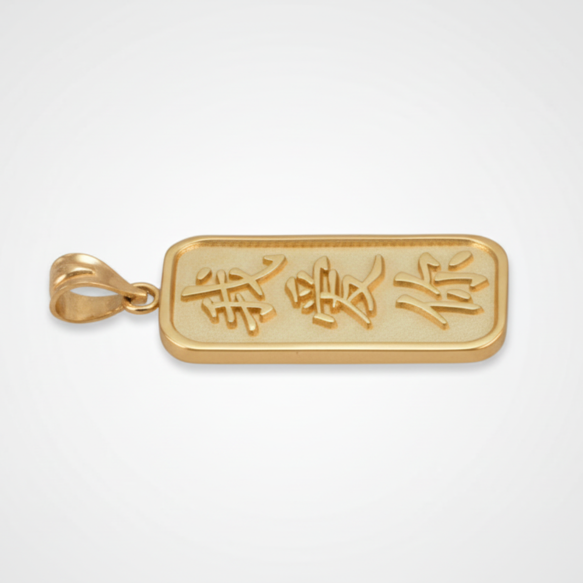 Gold pendant with engraved characters on a light gray background